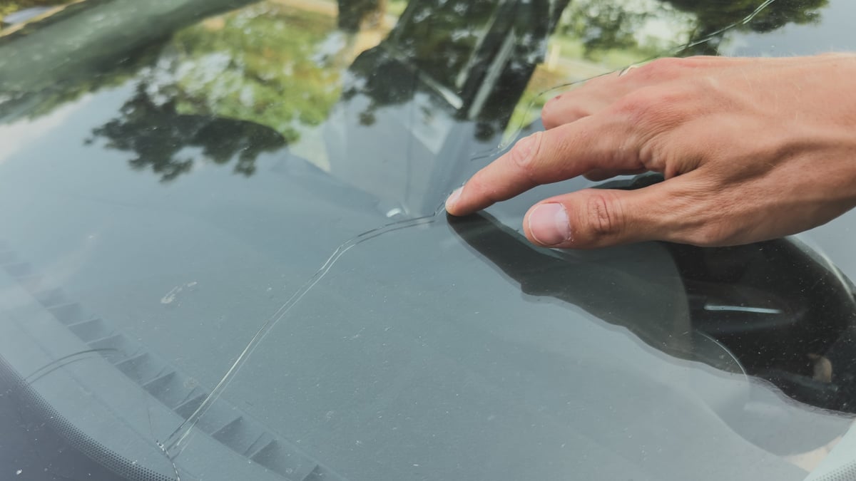 A long crack running across a car windscreen
